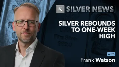 Frank Watson in front of silver news background